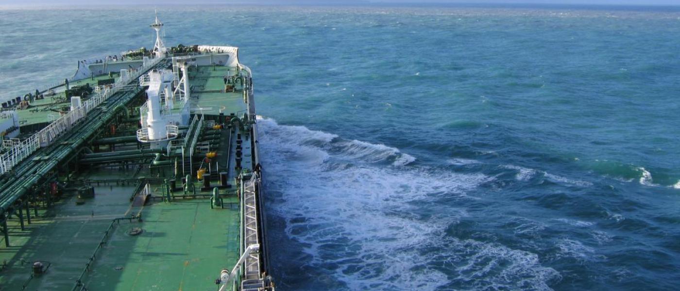 Click to view larger image A large ship steams ahead on the open ocean.