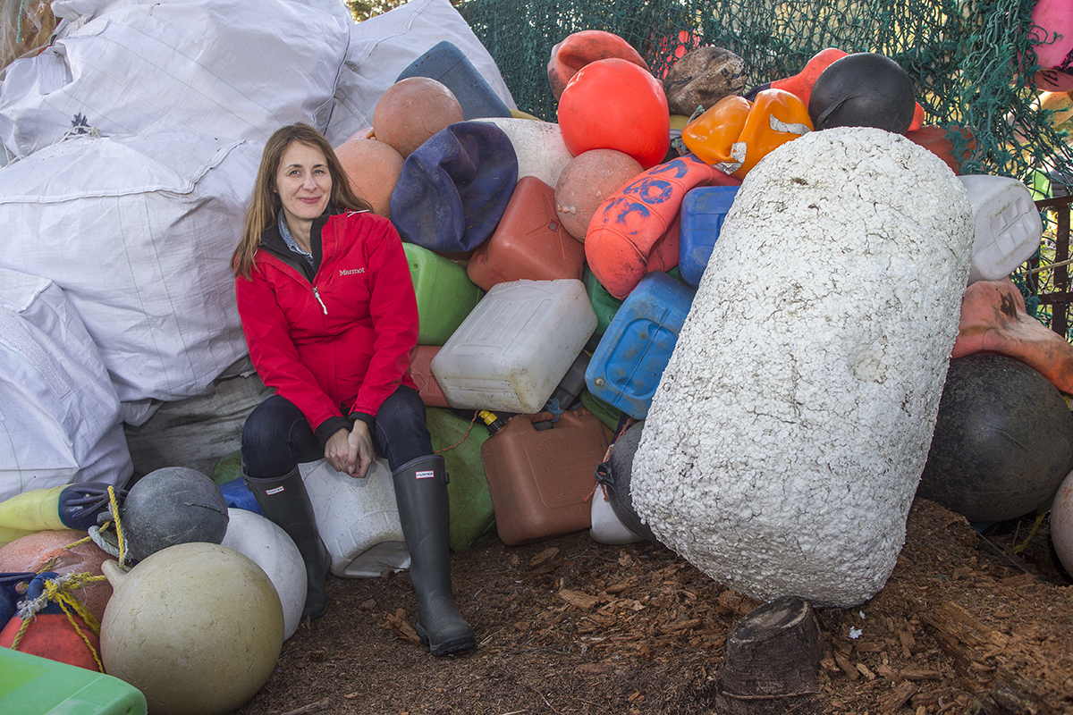 Click to view larger image women surrounded by plastic trash