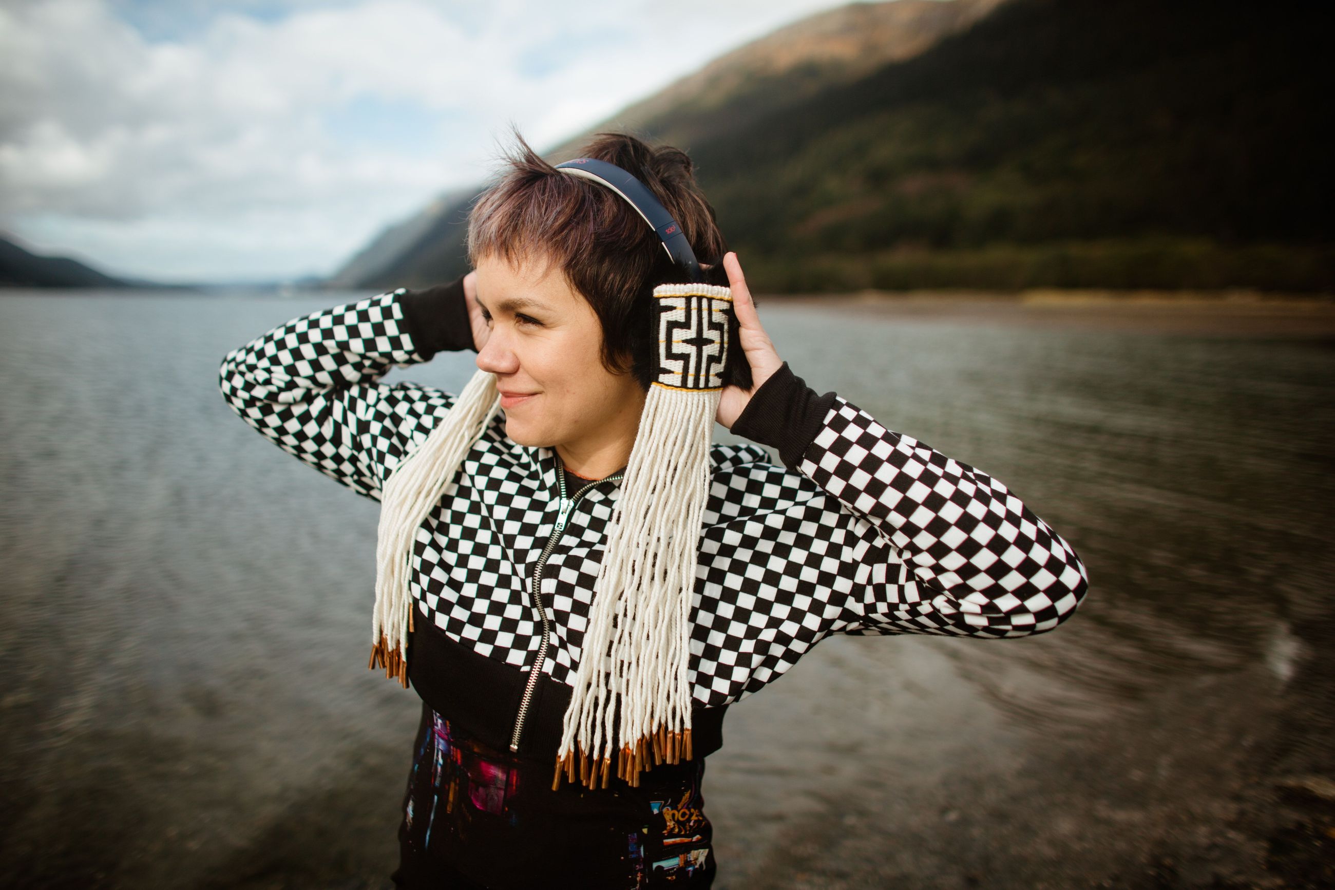 Woman wearing headphones with tribal decorations
