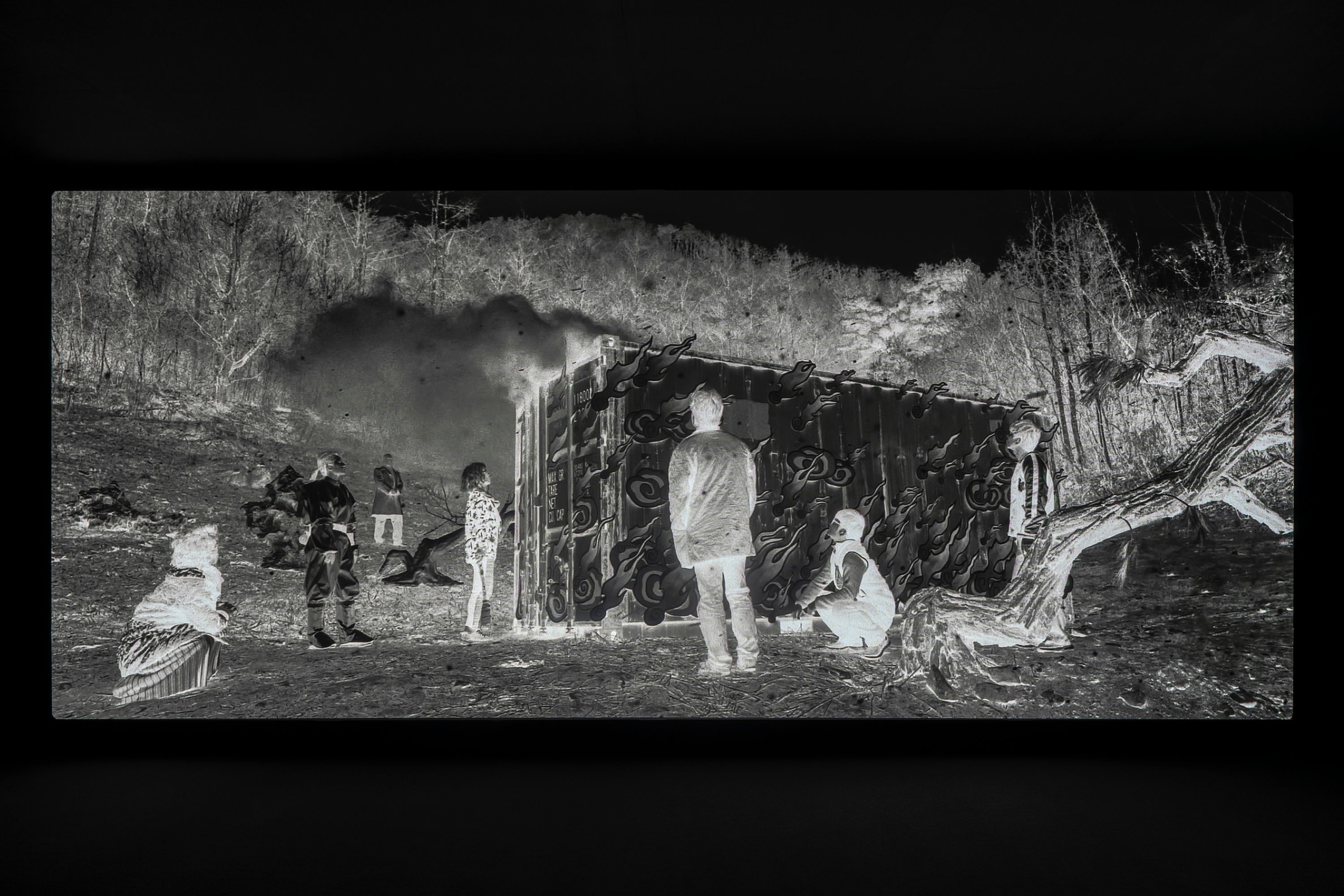 Black and white negative still image of people standing randomly in group