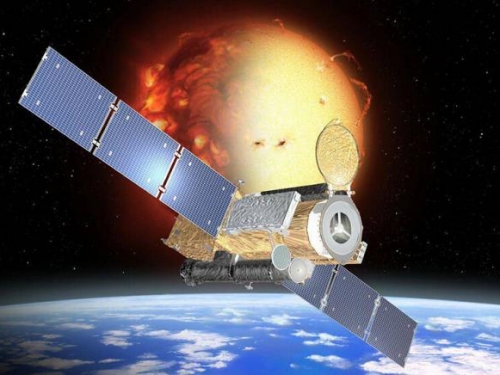 Artistic representation of the Hinode spacecraft with the Earth and sun in background.