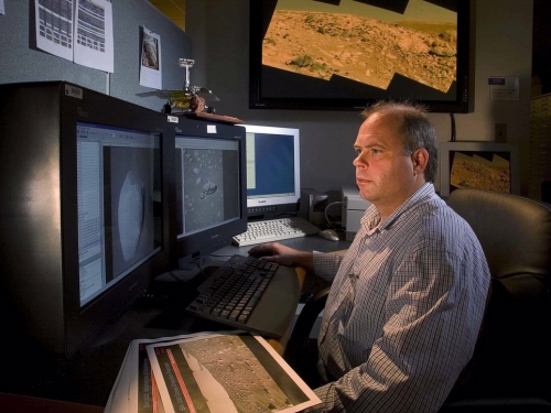 John Grant sits at his desk looking at a computer screen.