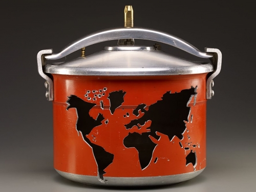 Red pressure cooker with image of a world map carved in the side