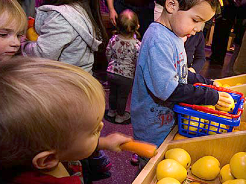 Children pretend grocery shopping.