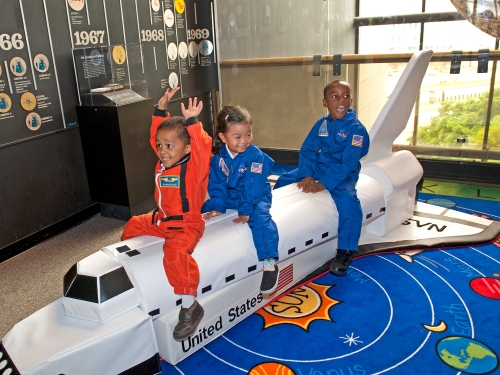 children playing on model of space shuttle