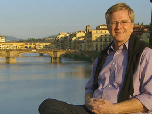 Rick Steves against backdrop of canal in FLorence