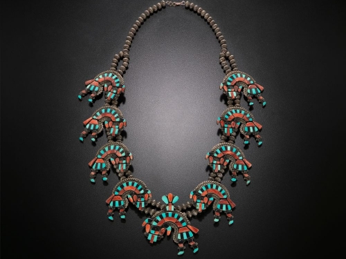 Necklace with blue and red jewels in abstract pattern.