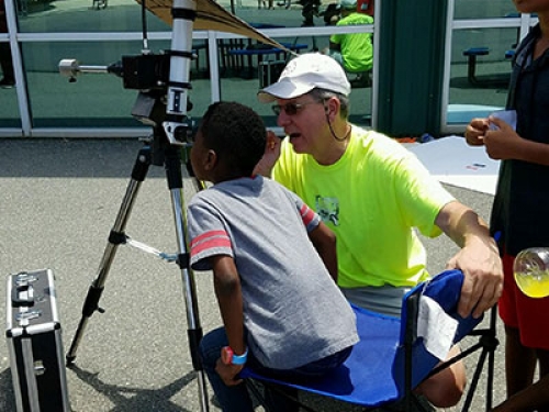 Kid using camera on a tripod
