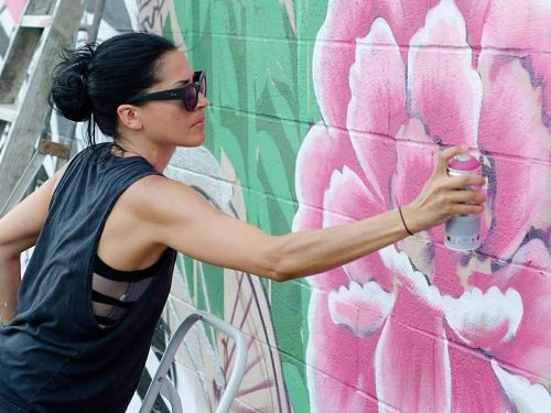 artist spray painting mural