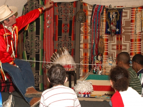 Children listening to older Native American man