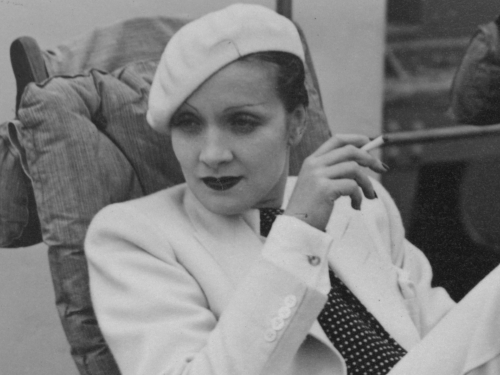 Marlene Dietrich in white beret, smoking