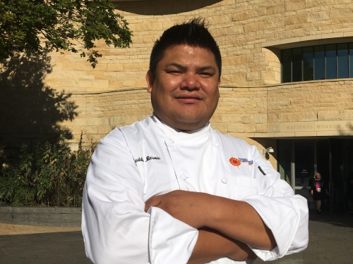 Bitsoie in chefs whites outside American Indian Museum
