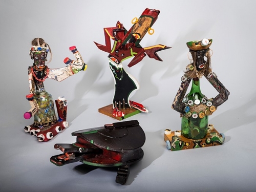 four folk art sculptures