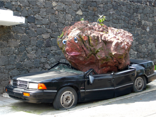 Car being crushed by rock