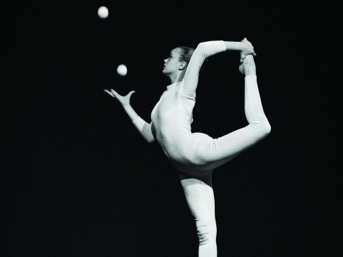 Female acrobat juggling