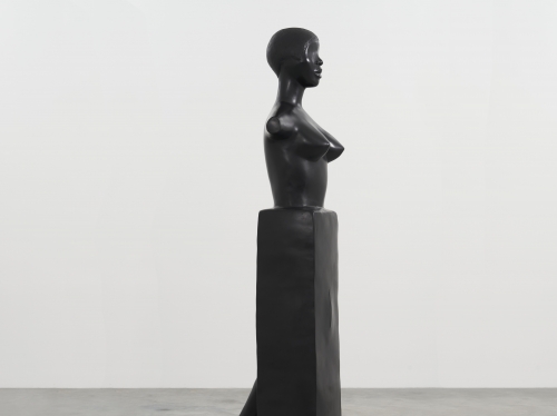 Sculpture of woman's torso and leg in profile