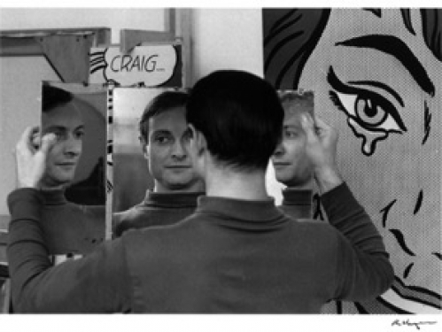 Artist Roy Lichtenstein in front of his paintings