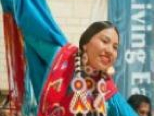 Native American woman dancing in traditional attire