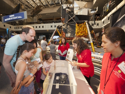 Family interacting with volunteer