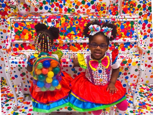 Two young girls in bright polka dot clothes in bright polka dot exhbition