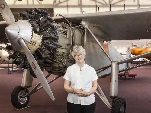 daughter of charles lindbergh poses with his plane