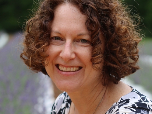 Woman with short brown hair smiling.