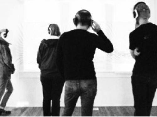 Black and white image of people listening