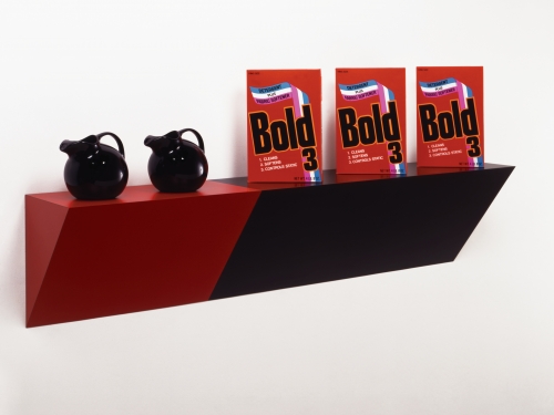red and black sculpture featuring detergent boxes and pitchers