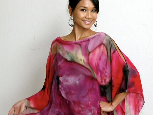 Woman modeling a colorful, slightly sheer, abstractly-patterned shawl