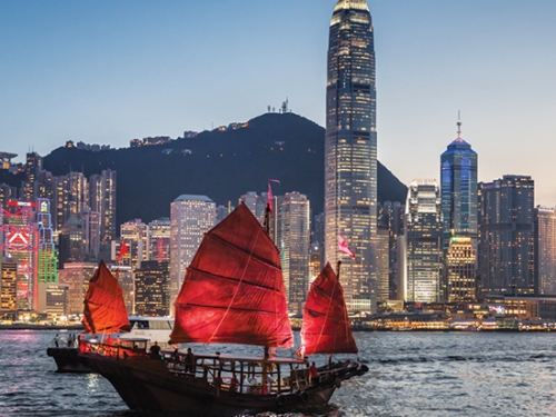 Traditional junk boat sailing in Victoria Harbour, Hong Kong