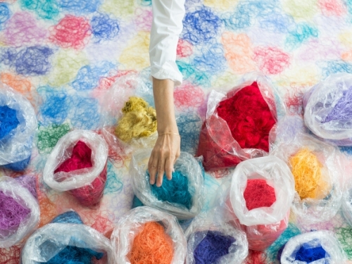 Bags of brightly colored thread seen from above