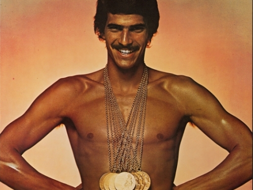 Mark Spitz in Speedo wearing gold medals