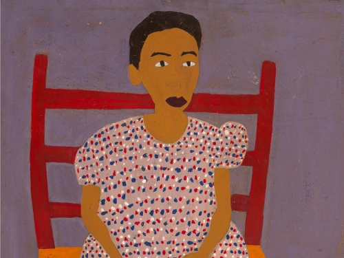 Image: A young African-American girl sitting in a red chair. Text: Grades PK–1