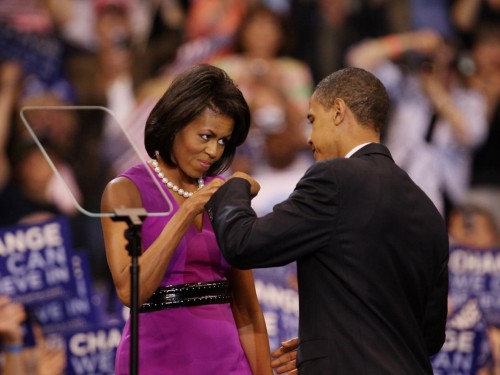 Michelle and Barack Obama bump fists.