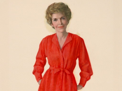 Nancy Reagan in a red dress with her hands in her pockets.