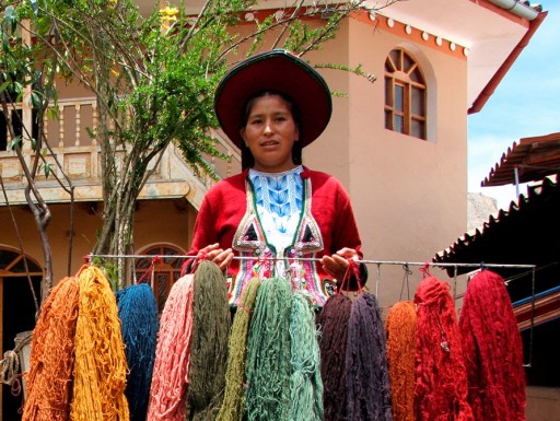 Peruvian woman holding colorful yarns.