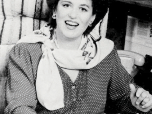 black and white photo of woman sitting at desk