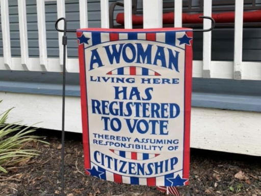red, white, and blue garden with text: "A Woman Living Here Has Registered to Vote Thereby Assuming Responsibility of Citizenshi