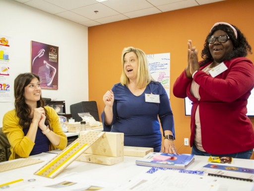 A group of educators participate in a science experiment
