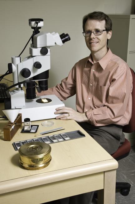 Researcher with microscope