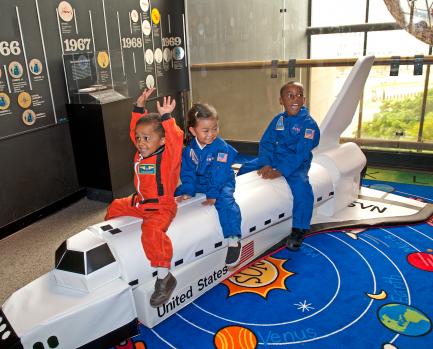 Children playing with model space shuttle