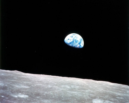 Earth rise photo of planet Earth on the horizon of the moon
