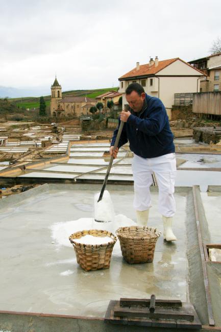 Man spreading salt to dry