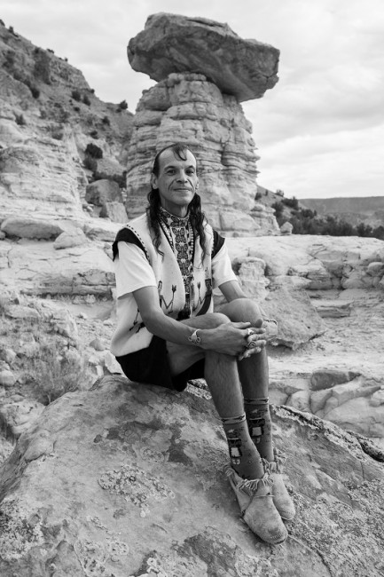 Archuleta sitting on a rock