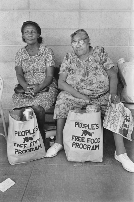 Click to view larger image Two women with bags of food