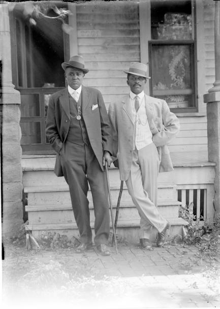 George W. Butcher and friend wearing suits and leaning on canes