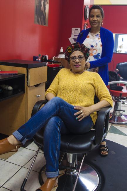 Woman in slaon with curlers in her hair