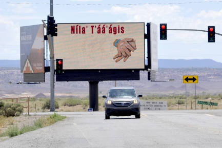 Car drives in front of billboard