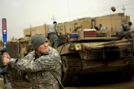 Soldier swinging baseball bat