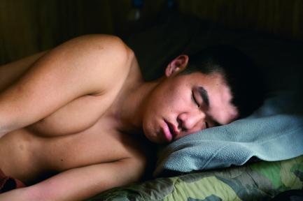 Man asleep on cot